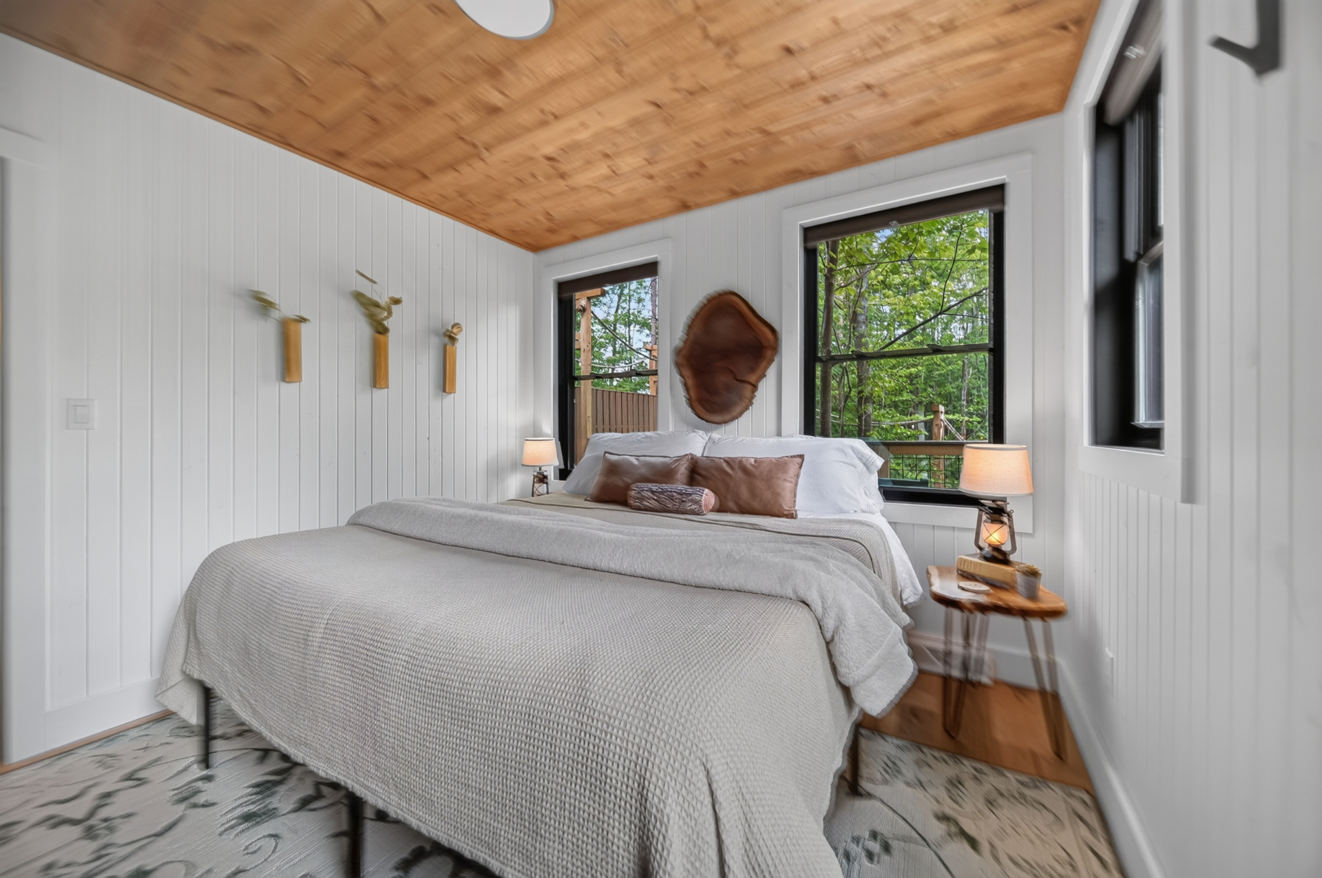 Lofty Pine — Bright main bedroom with views into the canopy.