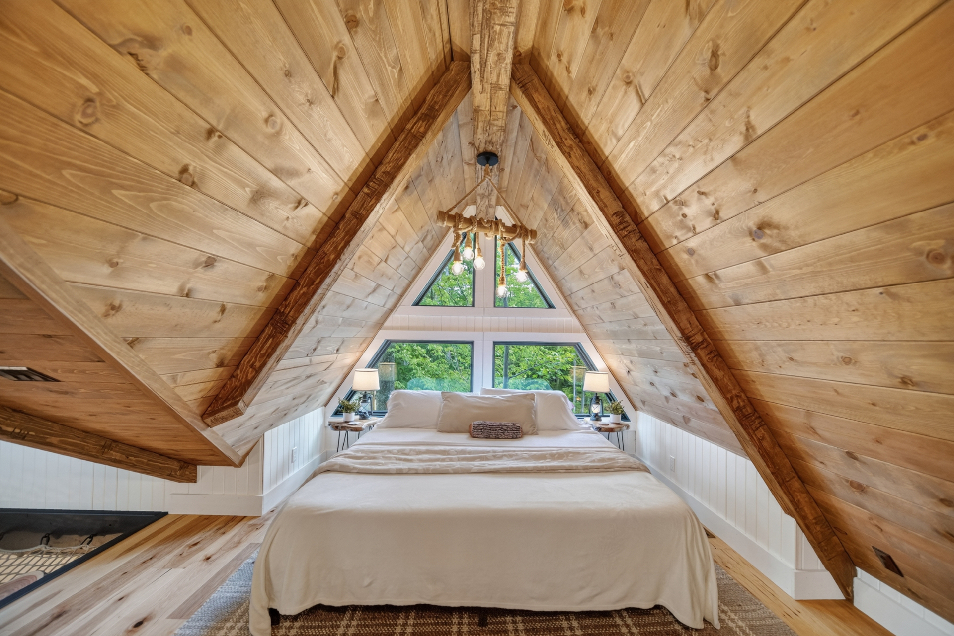 Lofty Pine — A-frame loft bedroom beneath the vaulted wood ceiling.